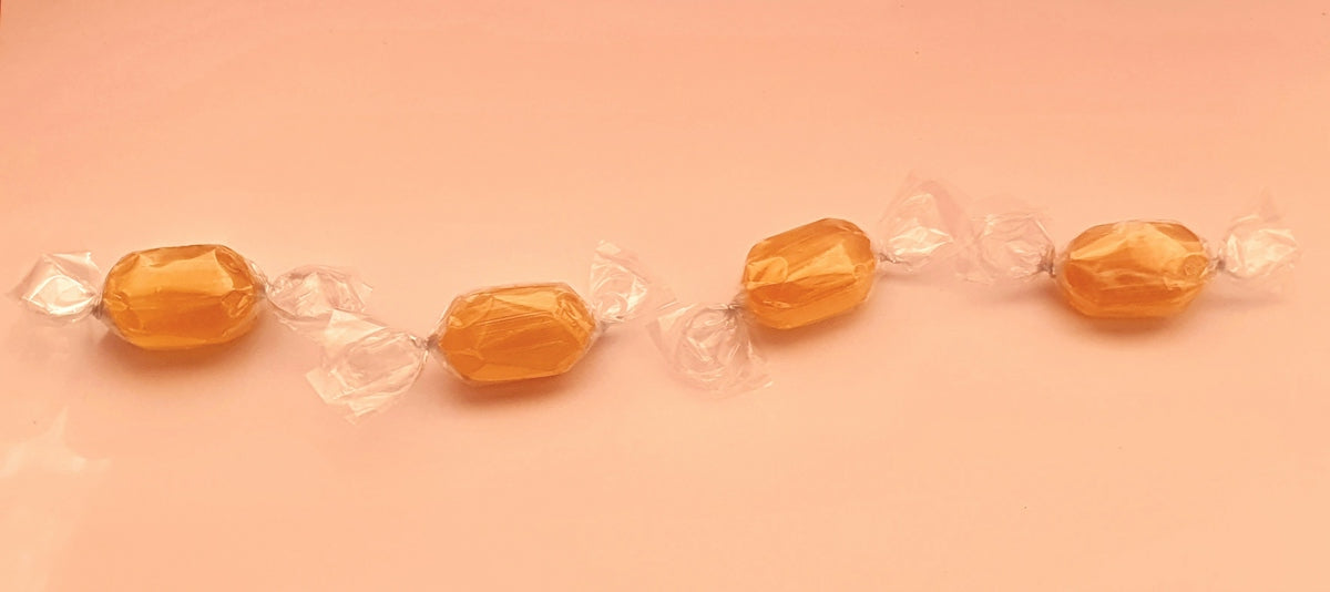 four yellow and white candy packs