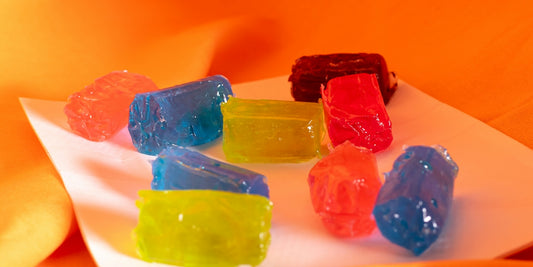 A bunch of gummy bears sitting on top of a white plate