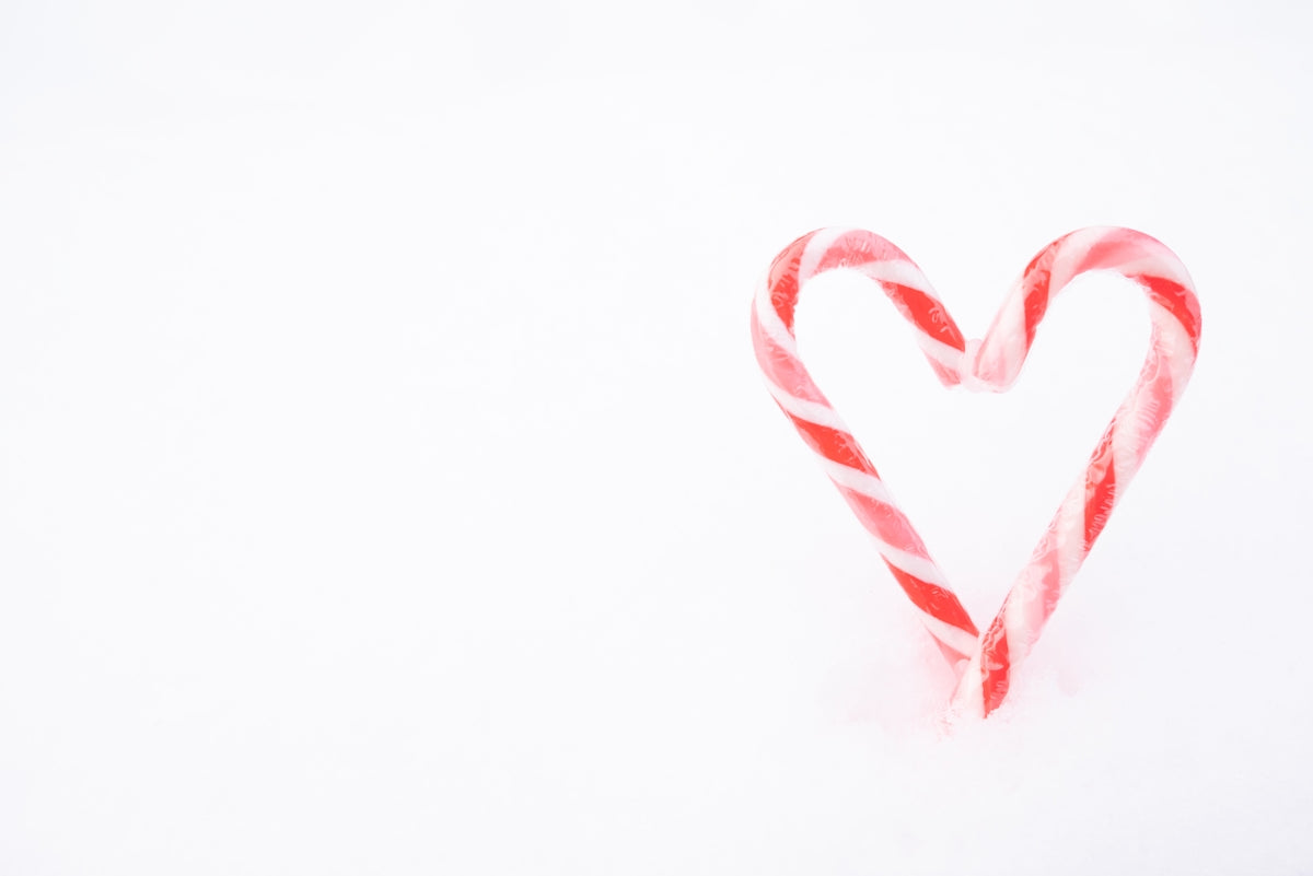 Two candy canes form a heart shape