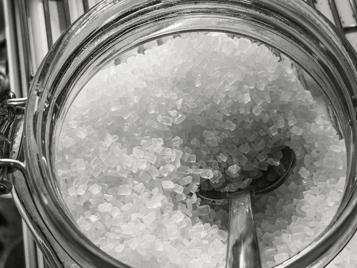 Close-up of coarse salt crystals in a glass jar