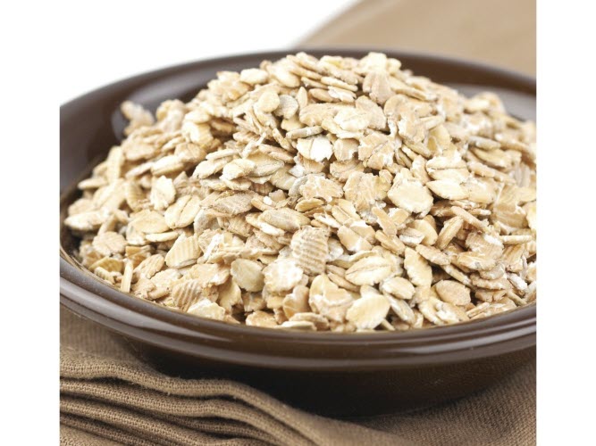 A bowl of 7 grain cereal uncooked with visible oats and flax seeds.