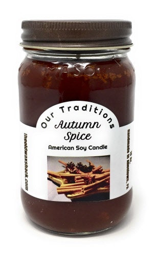 Autumn spice brown color candle with label showing cinnamon sticks and spices