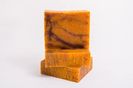 Two bars of all-natural Bay rum Soap marbled orange and brown soap stacked on a white background