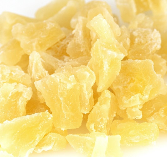 A close-up image of dried pineapple chunks.