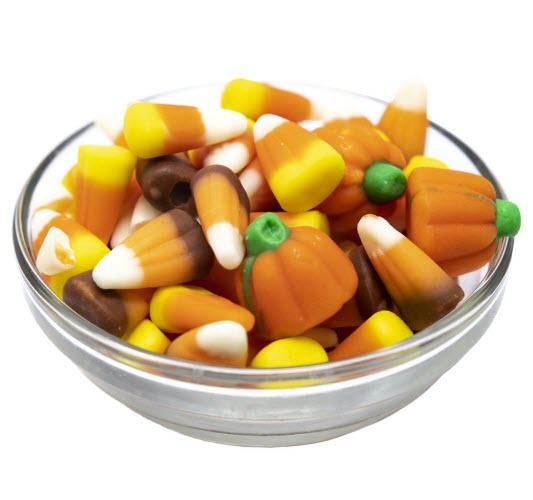 Candy corn and pumpkins candy in a clear candy dish