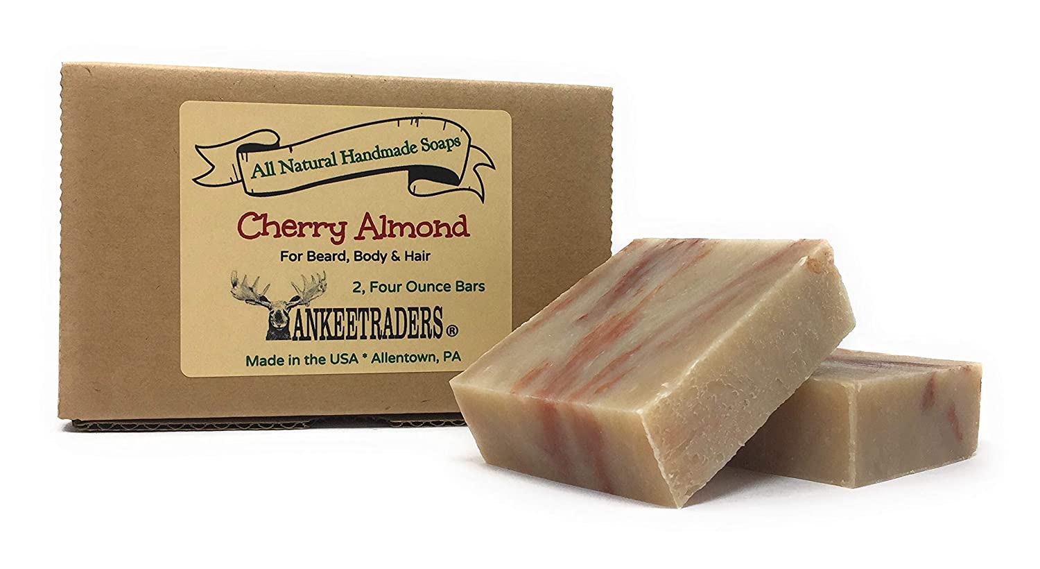 Two bars of cherry almond soap in front of a box labeled 'All Natural Handmade Soap Cherry Almond' by yankee traders