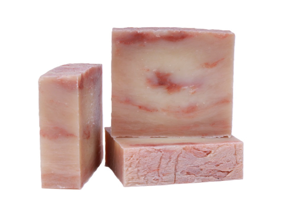 Three bars of cherry almond pink soap with a marbled pattern on a white background