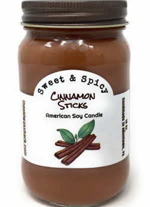 A 16 oz. soy candle in a mason jar with a label that reads 'Cinnamon Sticks' and depicts an image of cinnamon bark.