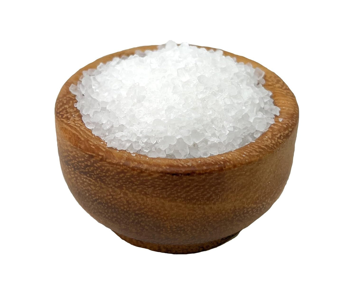 Wooden bowl filled with white coarse sea salt on a white background