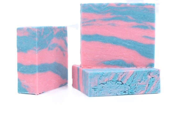 Three bars of pink and blue marbled Cotton Candy All Natural soap bars on a white background