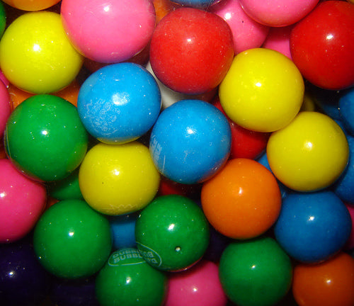A close-up image of colorful assorted Dubble Bubble gumballs, without any packaging visible.