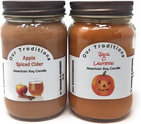 Two jar candles, one labeled 'Apple Spiced Cider' and the other 'Jack O Lantern', sold by YANKEETRADERS