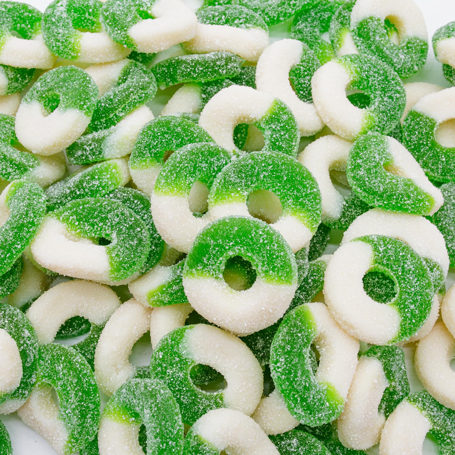 Close-up of green and white gummy candy rings.
