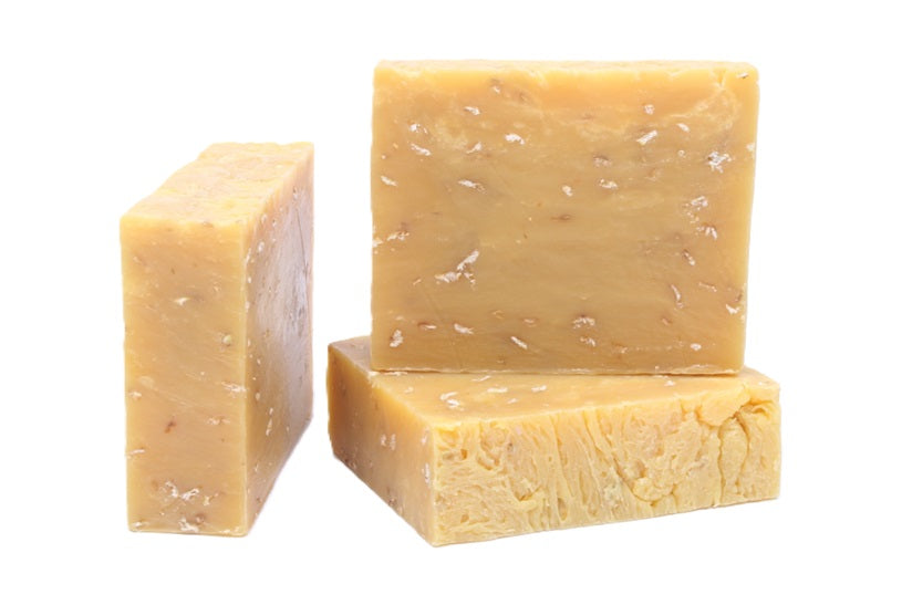 Three bars of Hoppin Ale natural soap with specks of oatmeal on a white background