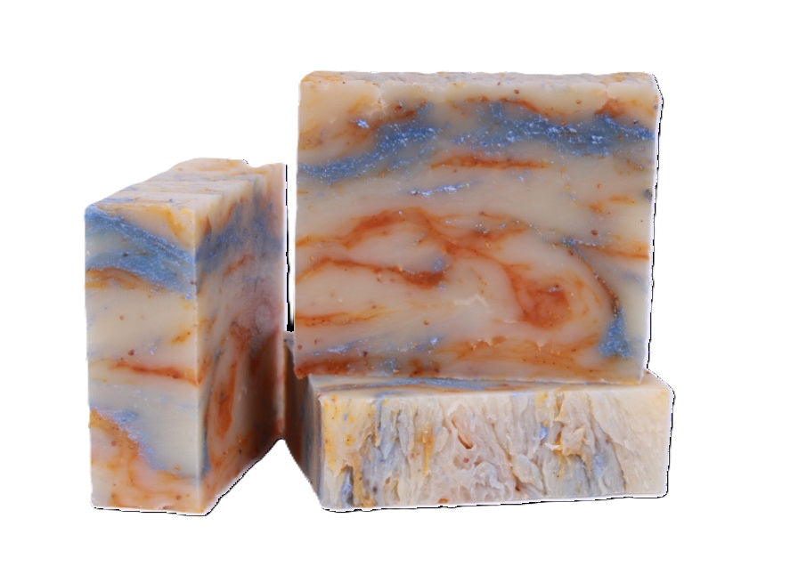 Three bars of Monkey Farts Natural soap with a marbled pattern on a white background