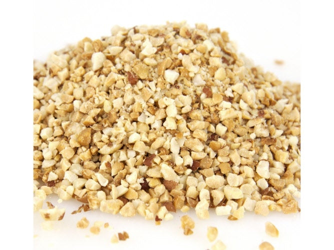 A pile of granulated dry roasted peanuts on a white background