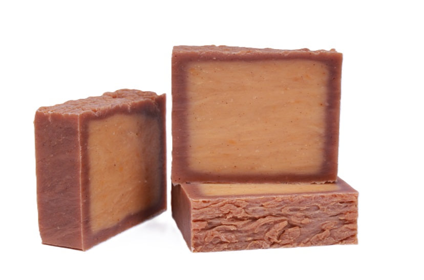 Three bars of pumpkin beer all natural soap on a white background