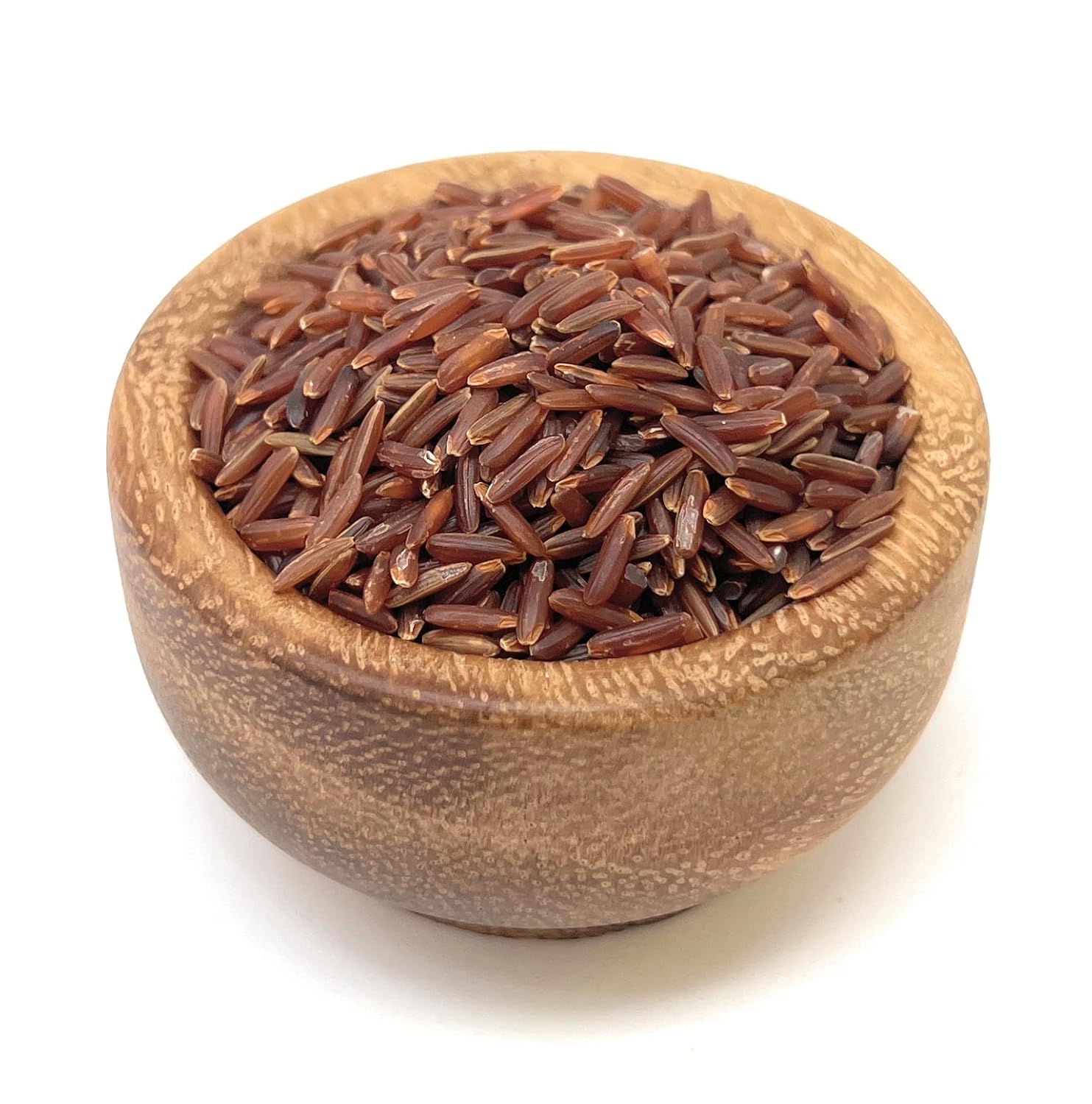 Wooden bowl filled with red rice on a white background