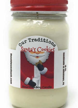 Santas cookie white colored soy candle in a 16 oz. mason jar with a red lid.
