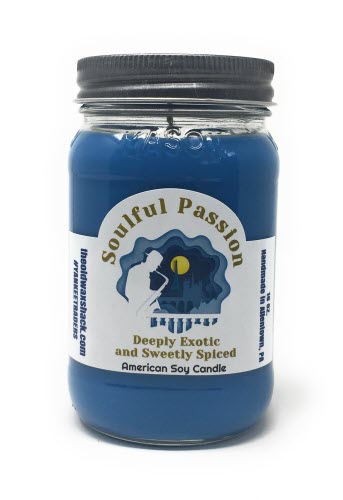 A blue soy candle in a mason jar with a label that reads 'Soulful Passion' and 'Exotic, Sweet & Spicy'. The candle is depicted with a cool blue tone and a decorative label design.