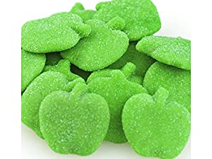 A pile of sour green apple gummy candies with a sugary coating.