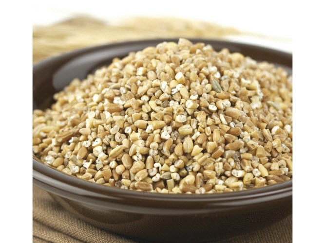 A bowl of cracked 9 grain cereal mix, including a variety of grains such as wheat, rye, oats, and flaxseed
